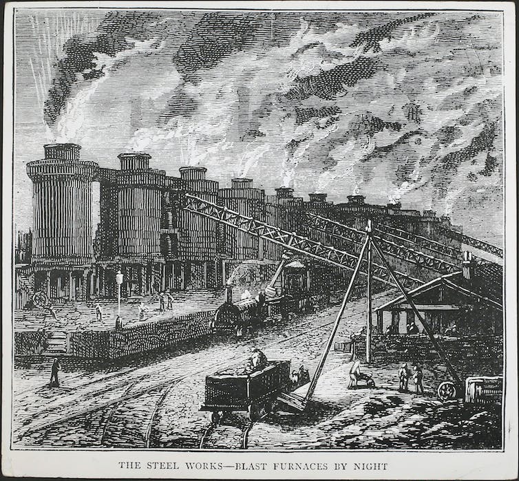 Una ilustración de una fila de hornos gigantes de los que sale vapor, vagones de ferrocarril que transportan carbón y una locomotora, con trabajadores corriendo.